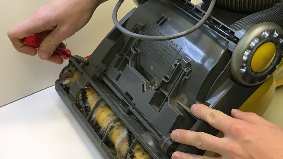 tech repairing a vacuum