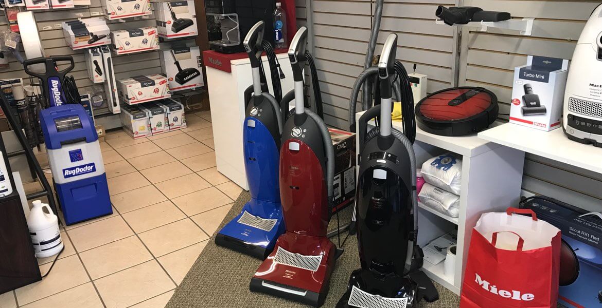 Vacuum store. RugDoctor shampooer, three upright vacuum cleaners, Miele RX2 robot vacuum.